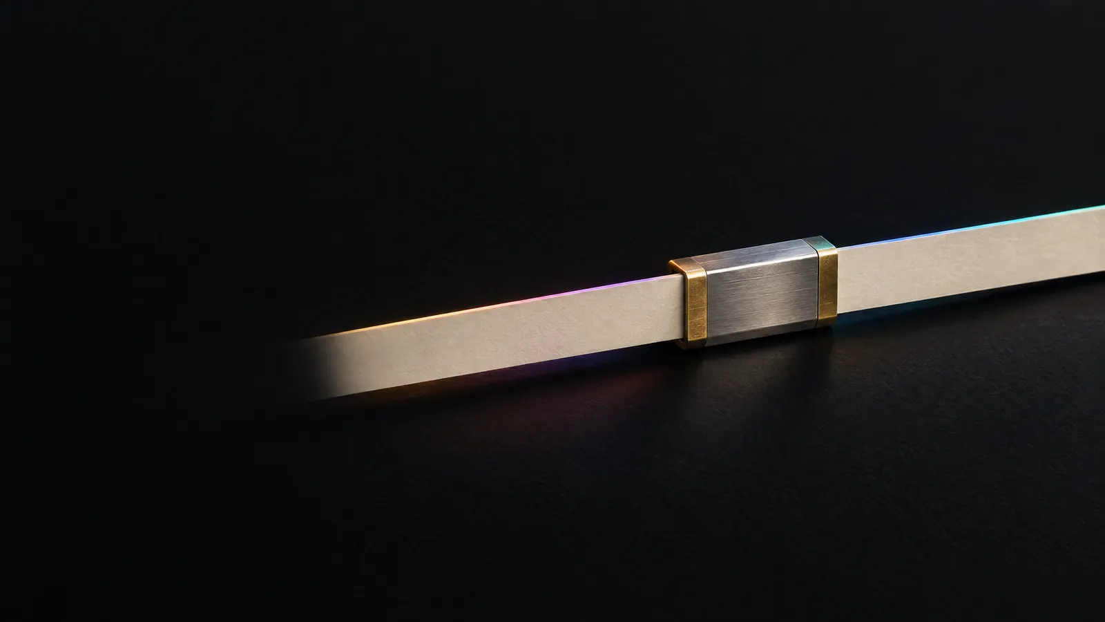 Two cream paper strips joined by a steel splice clamp into one line, for marketing and sales systems connected without losing data.
