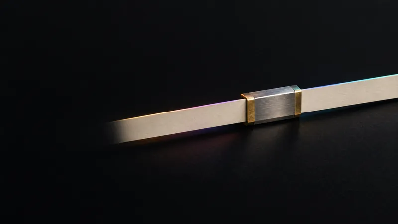 Two cream paper strips joined by a steel splice clamp into one line, for marketing and sales systems connected without losing data.