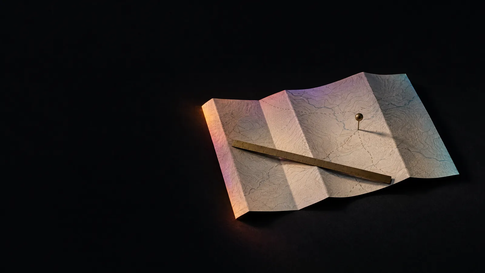 A folded cream map with a brass pin and ruler, an operator playbook for engaging a fractional CMO.